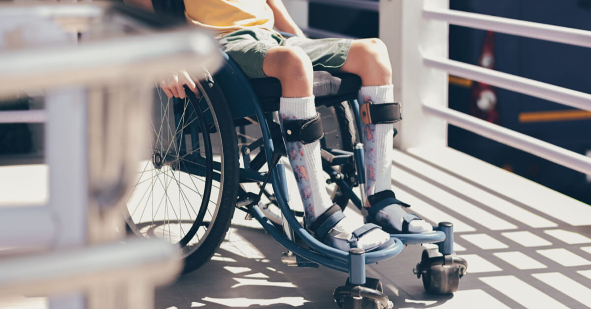 Young man with disability using wheelchair by himself on public ramps in hospitals or schools background, Pictures of the facilities or equipment and transportation for people with disabilities.